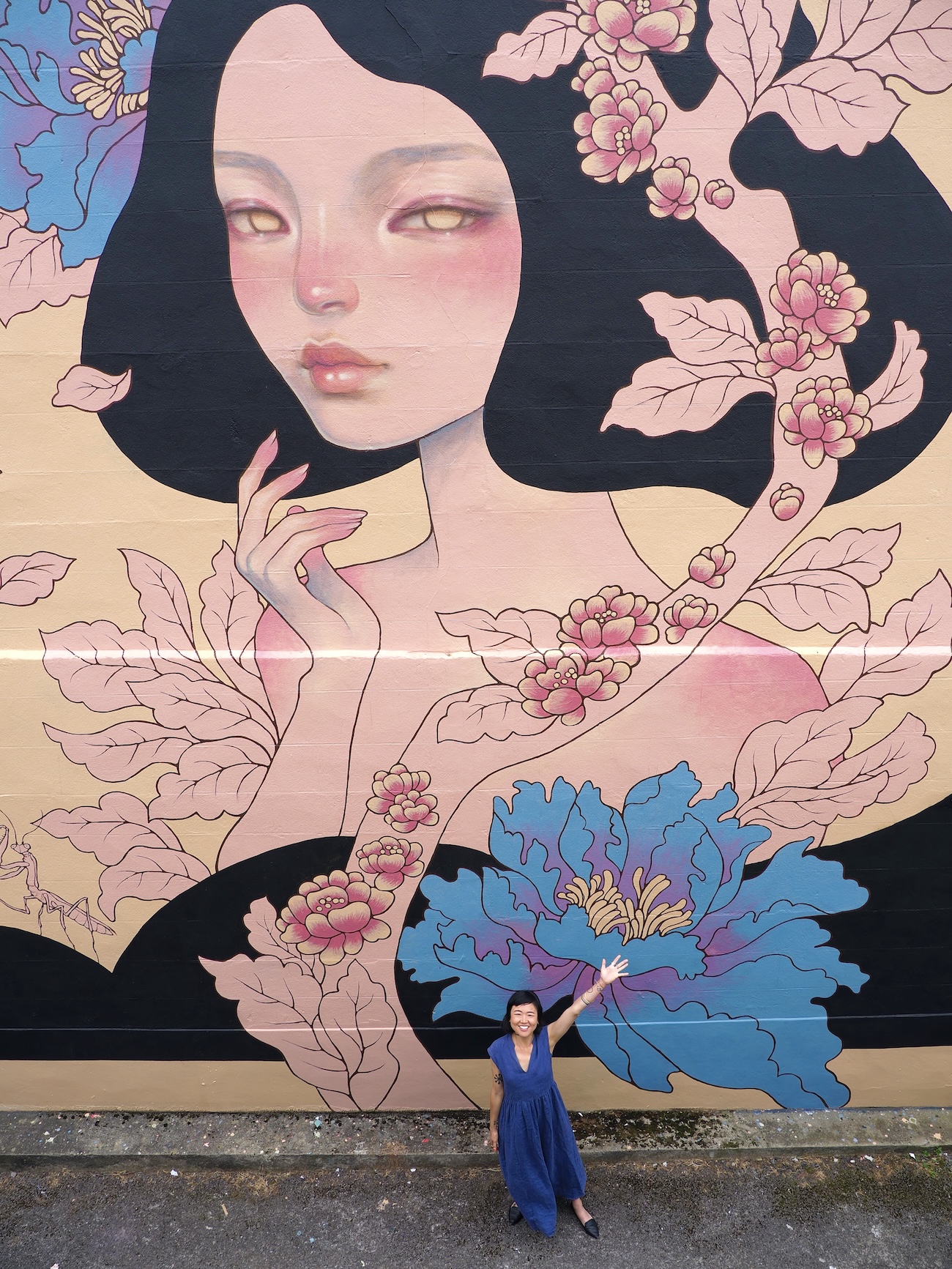 Audrey Kawasaki Posing in Front of Her Mural