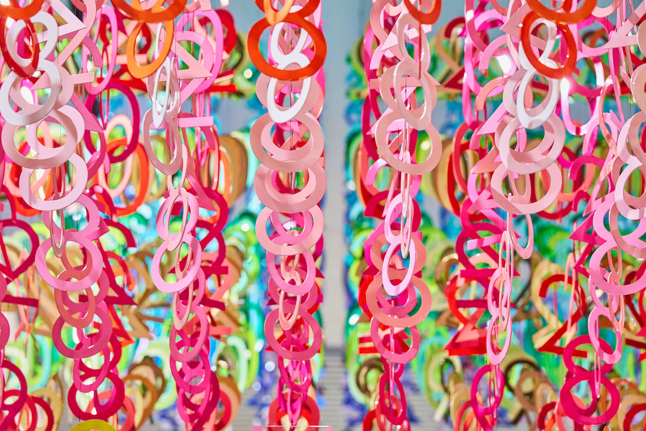 Colorful numerals hang in overlapping rows as part of Emmanuelle Moureaux's FLOW installation.