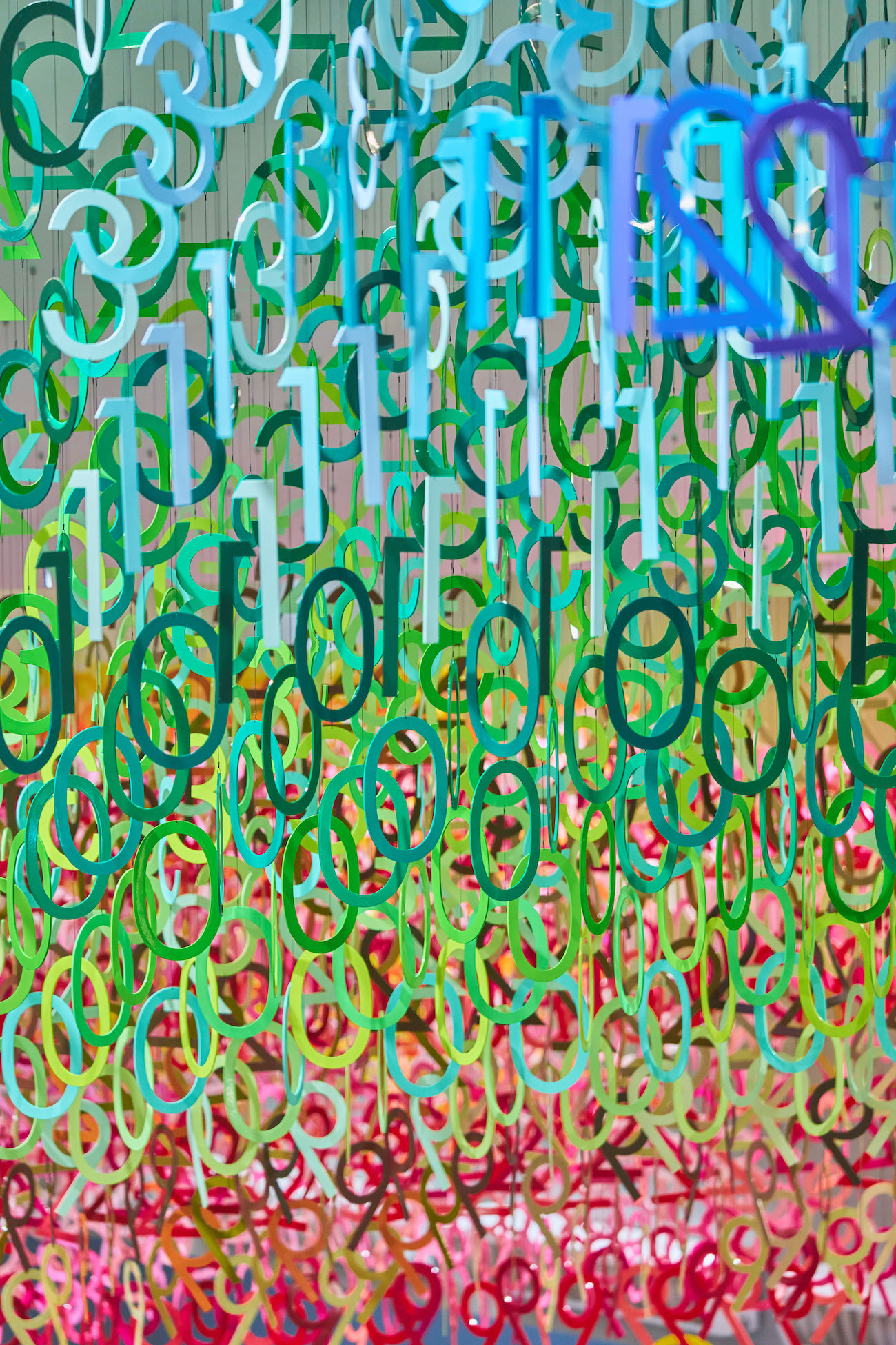 Colorful numerals hang in overlapping rows as part of Emmanuelle Moureaux's FLOW installation.
