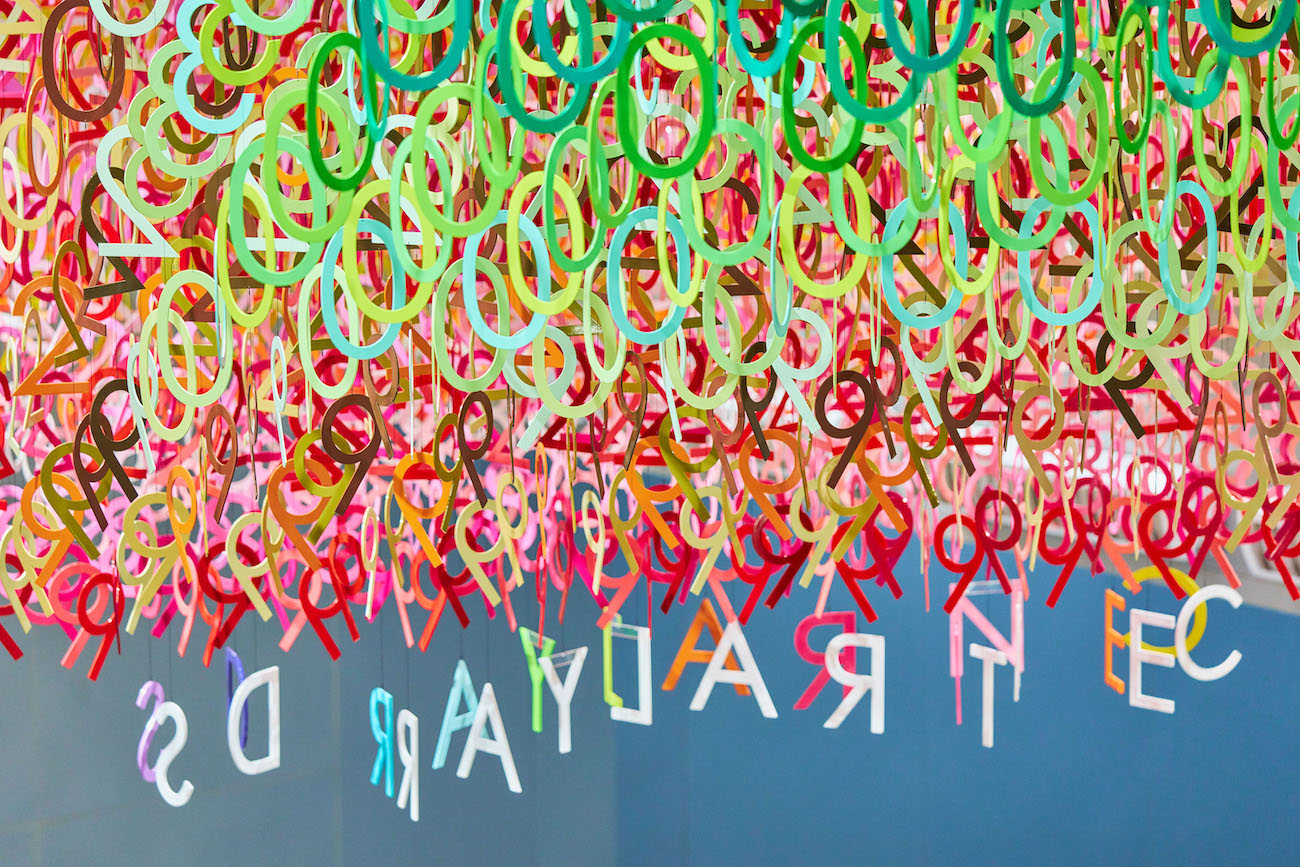 Colorful numerals hang in overlapping rows as part of Emmanuelle Moureaux's FLOW installation.