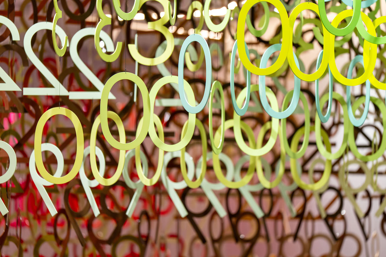 Colorful numerals hang in overlapping rows as part of Emmanuelle Moureaux's FLOW installation.