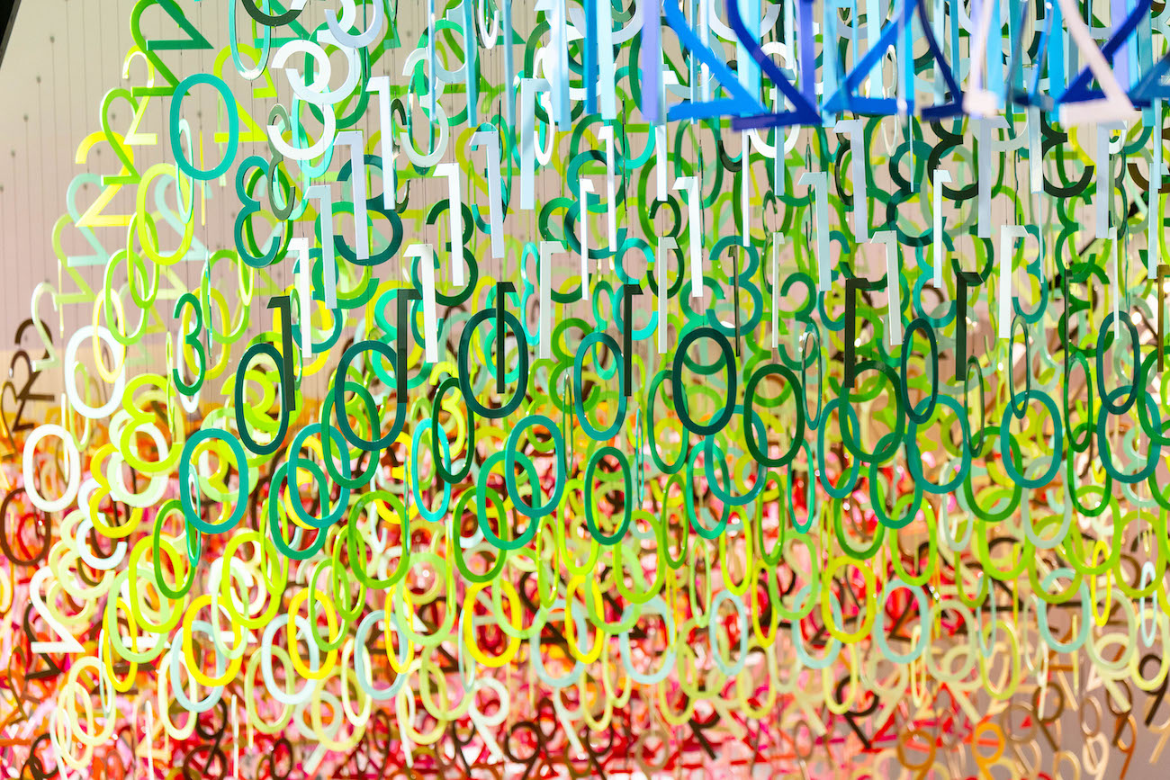 Colorful numerals hang in overlapping rows as part of Emmanuelle Moureaux's FLOW installation.