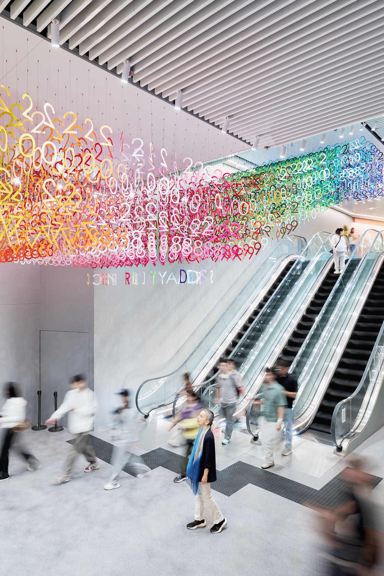 Colorful numerals hang in overlapping rows as part of Emmanuelle Moureaux's FLOW installation.