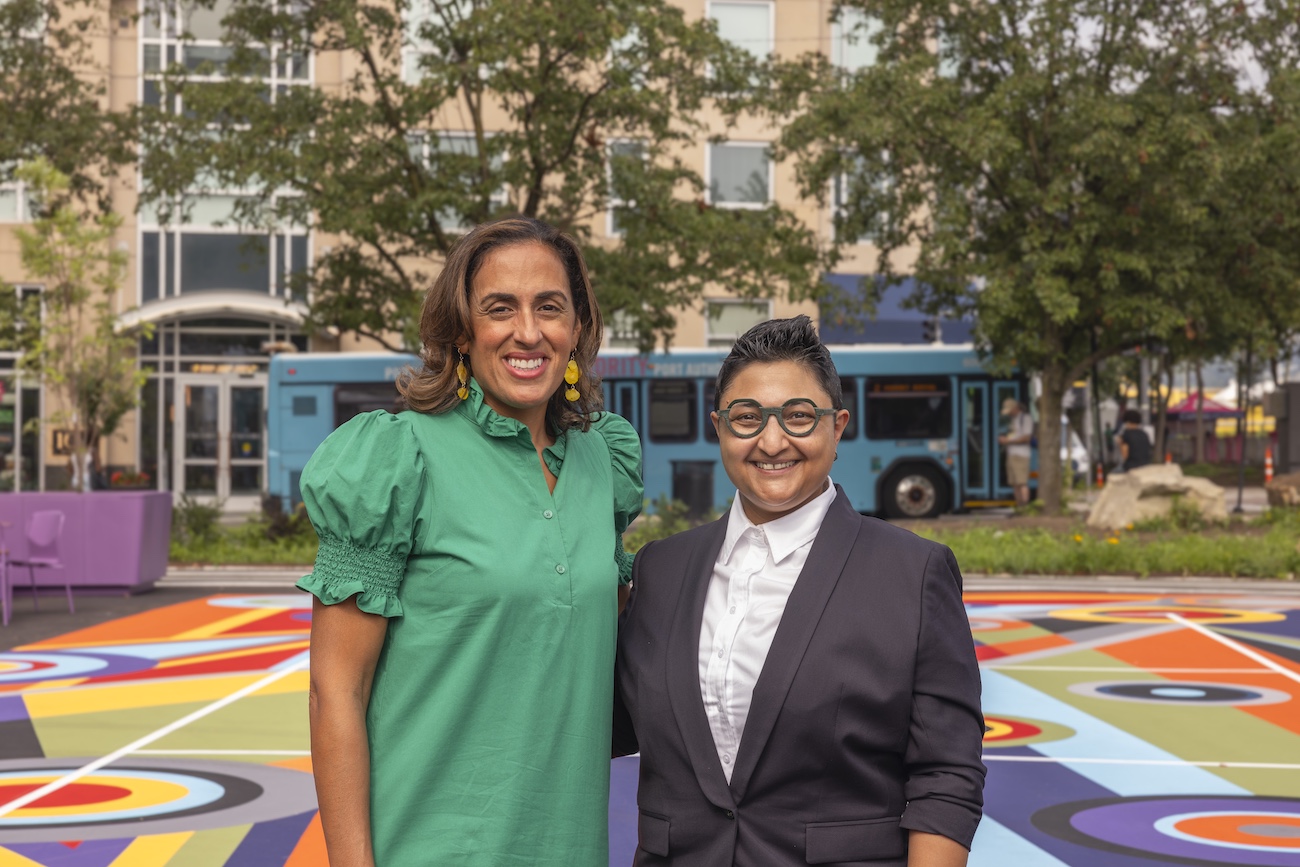 Artist and curator in front of pickleball courts.