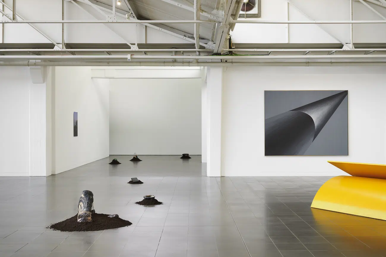 Installation View Nkisi, Nzita Dia Nza, 2022, mixed-media stone sculptures, infinity cassette tape on loop, soil, Courtesy of the Artist.