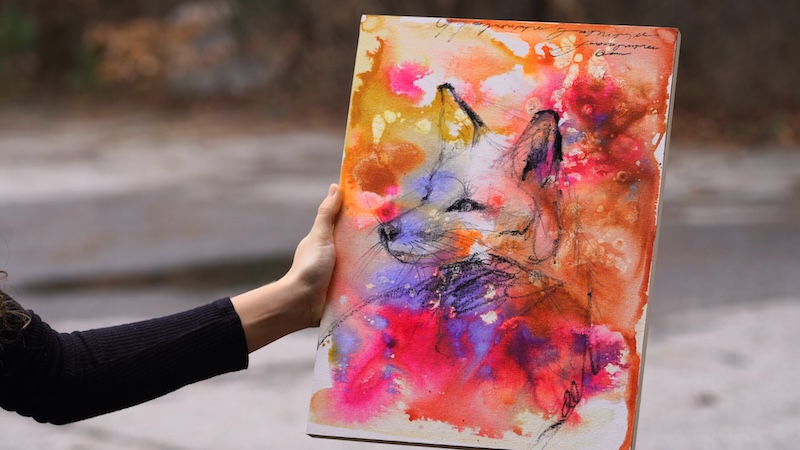 Artist Dimitra Milan Working on an Painting of a Fox on an Abstract Background