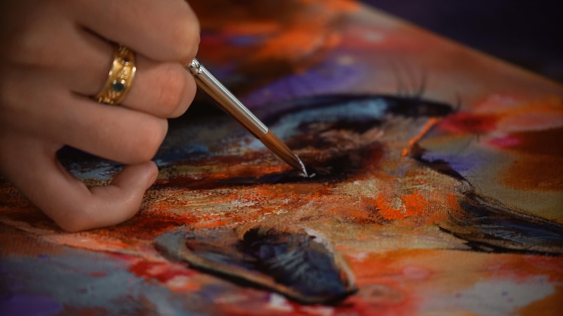 Artist Dimitra Milan Working on an Painting of a Fox on an Abstract Background