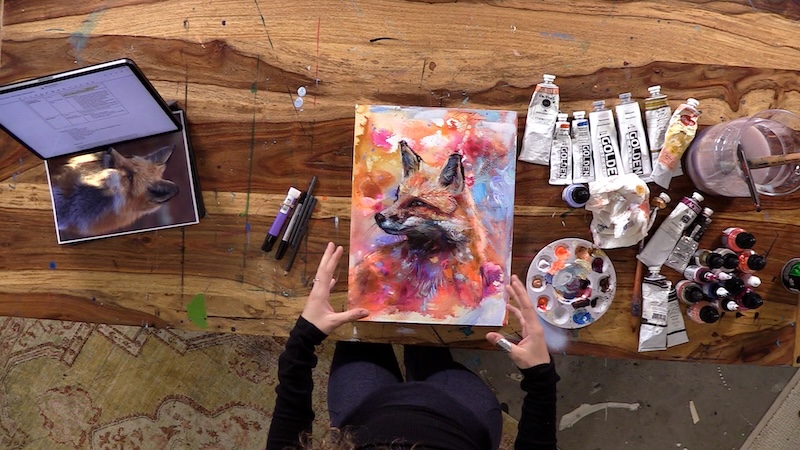 Artist Dimitra Milan Working on an Painting of a Fox on an Abstract Background