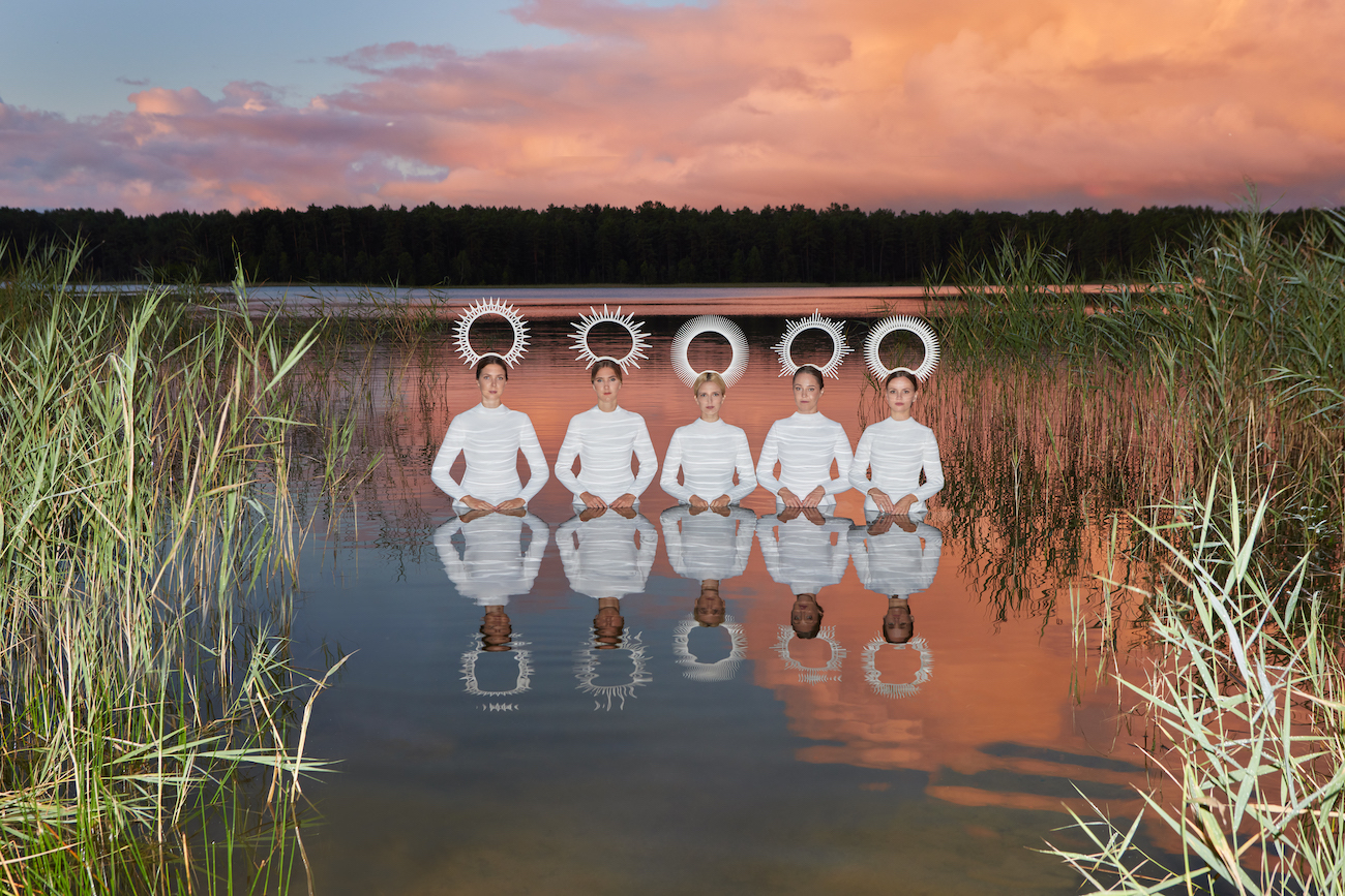 Photograph of 5 people dressed in white standing in water taken by Julia Buruleva