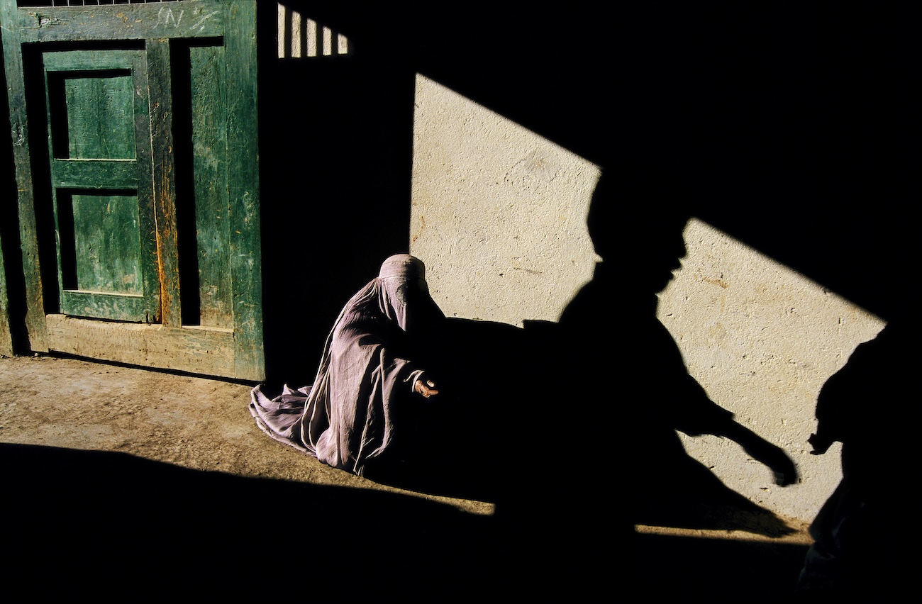 Beggar and shadow, Grand Ayatollah Mir Ali Ahmad Hojjat Mosque, Kabul, Afghanistan.
