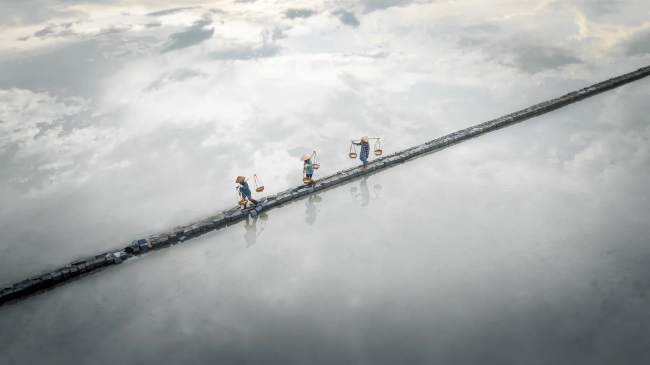 Workers in salt pools in Vietnam. 