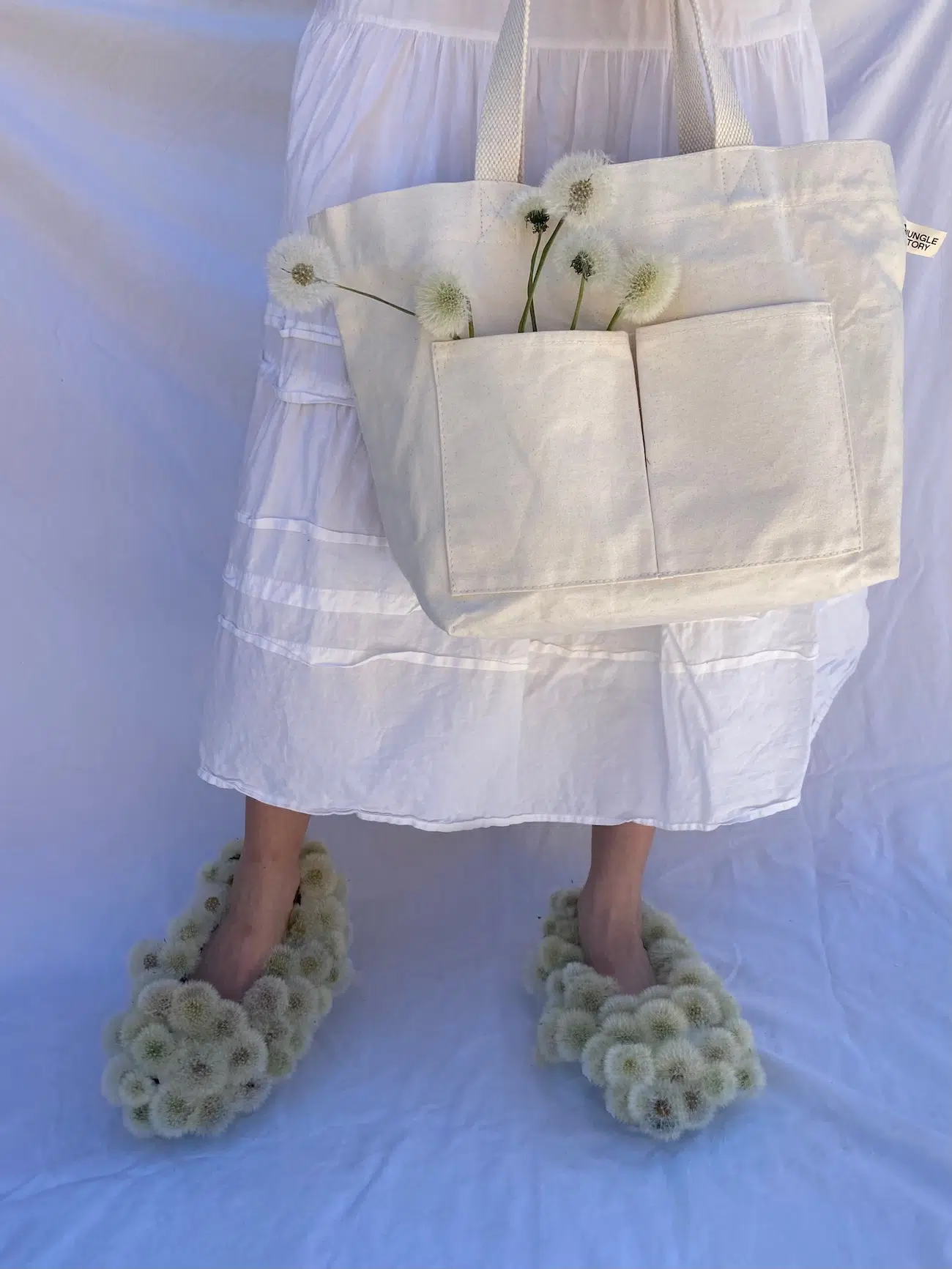 Photo of girl in white dress with dandelion shoes. 
