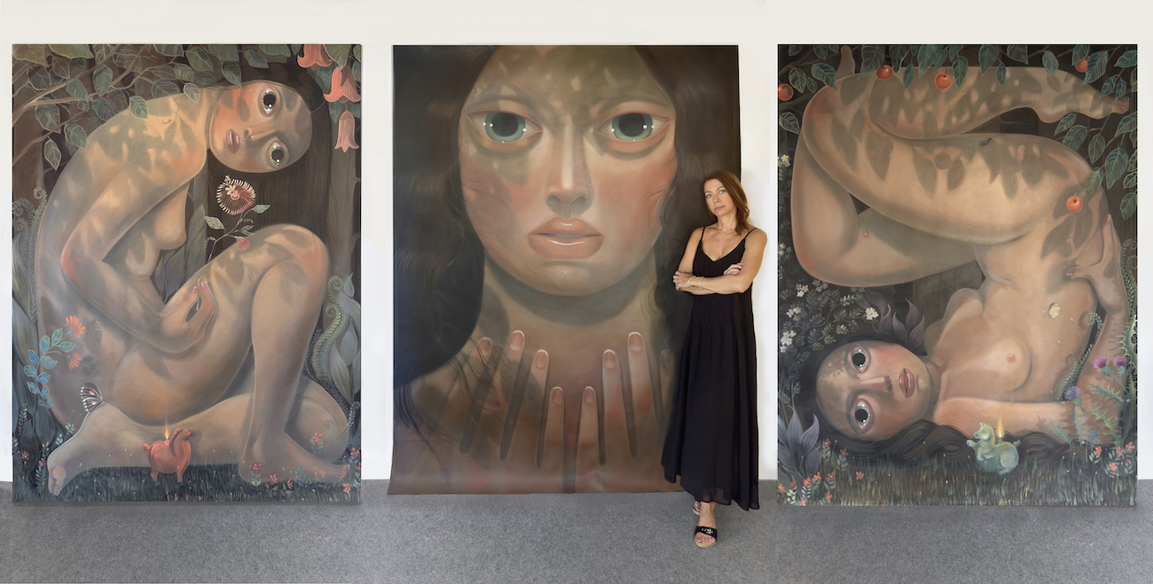 Portrait of Tania Marmolejo with paintings