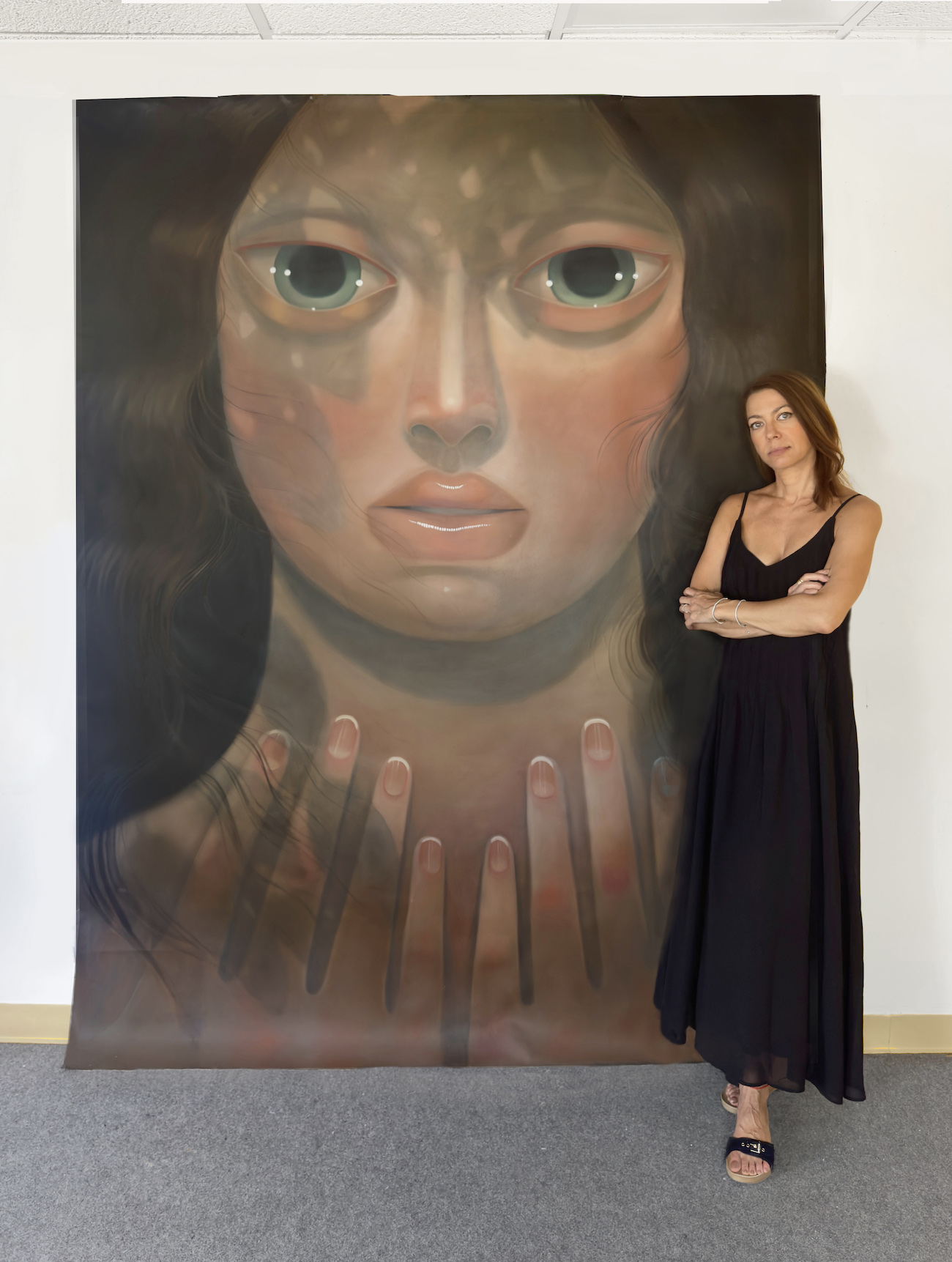 Portrait of Tania Marmolejo with paintings