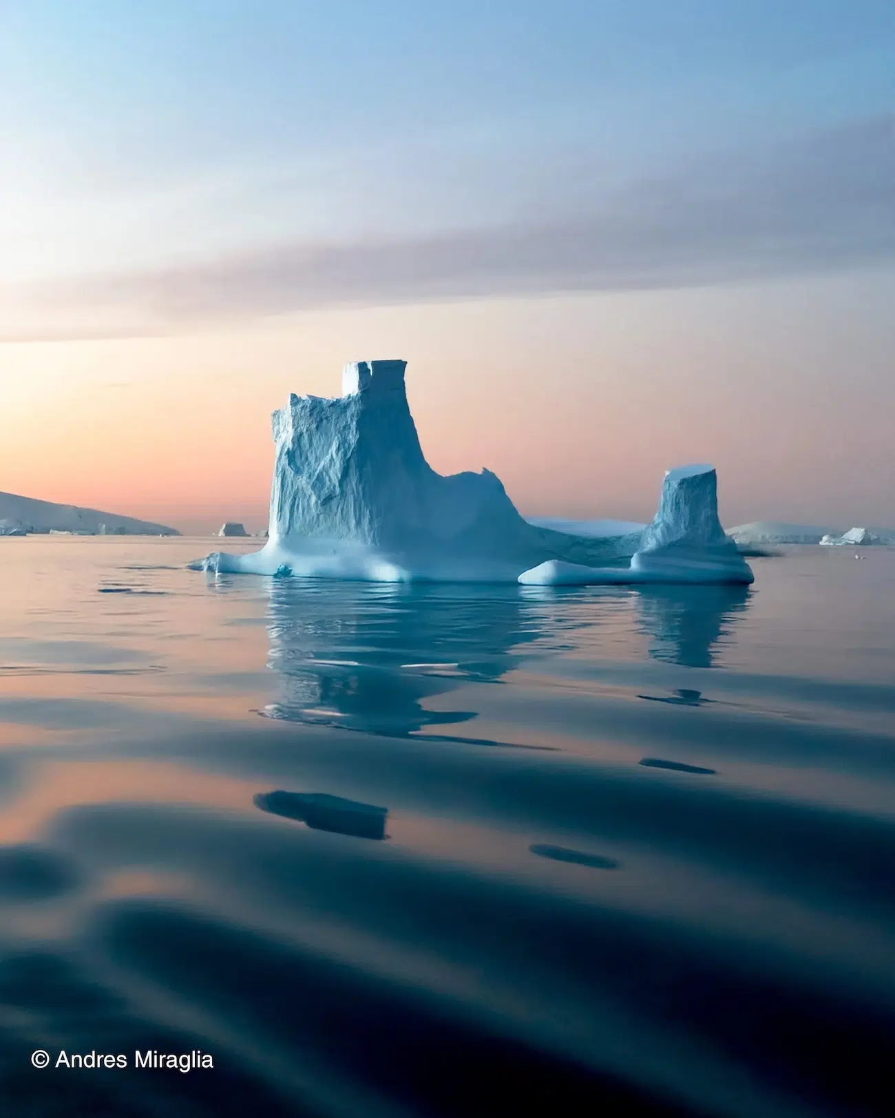 Photo of icebergs and pink sunset. 
