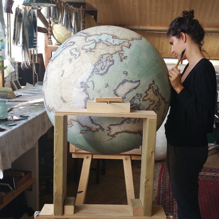 Woman Making a Giant Globe