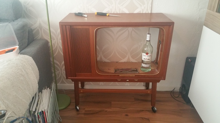quirky diy transforms obsolete tv into colorful liquor cabinet