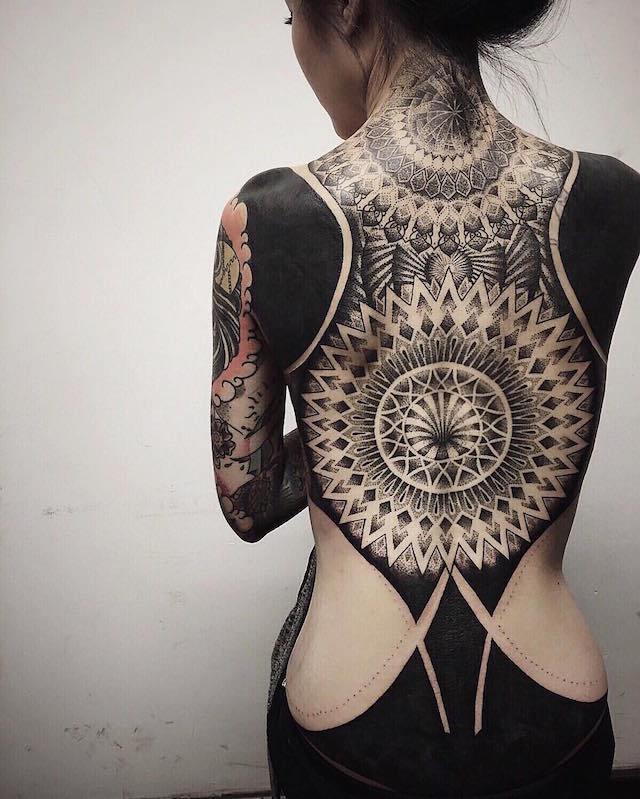 "Blackout Tattoo" Trend Cloaks the Body in Black Ink to