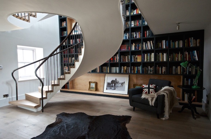 Spiral Staircase Effortlessly Flows By Floor To Ceiling Bookcase