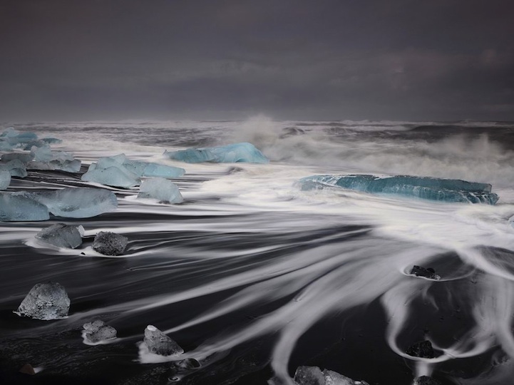 Black Sand Beach in Iceland is Dotted with Turquoise Icebergs