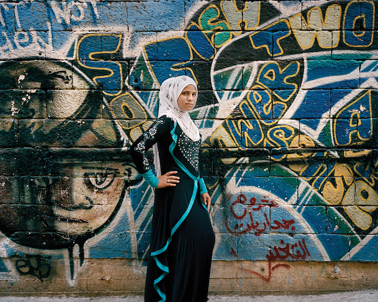 Refugee Girl Against City Walls Of Lebanon