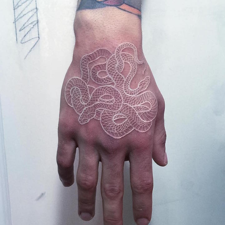 Intricately Intertwining Snake Tattoos Using Black and White Ink