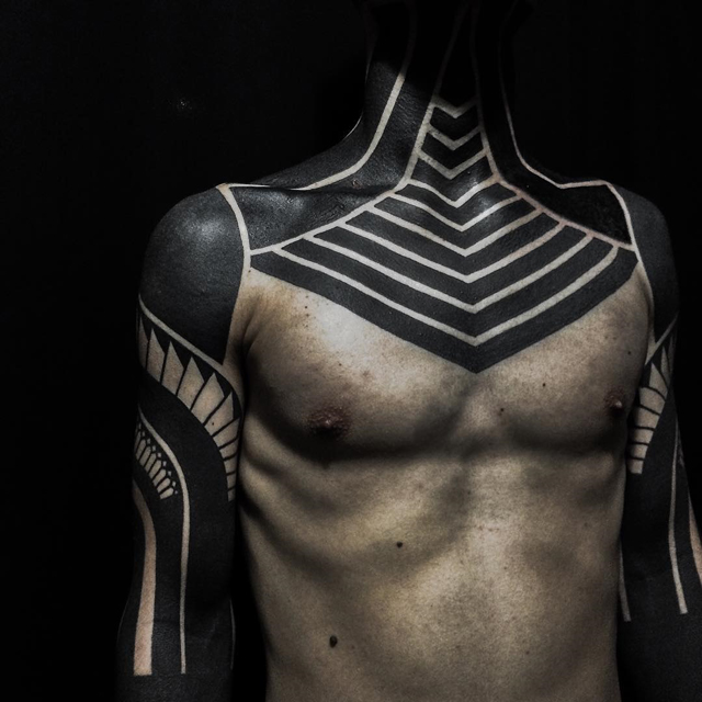 "Blackout Tattoo" Trend Cloaks the Body in Black Ink to Make a Bold